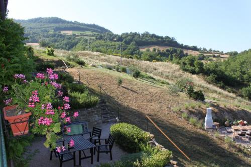a balcony with a table and chairs and flowers at Agriturismo Carincone in Pergola