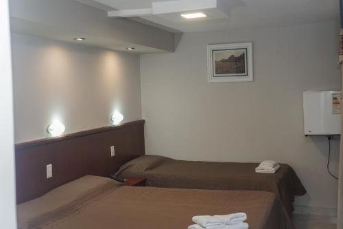 a room with two beds in a room with aperature at Hotel Garden in San Miguel de Tucumán