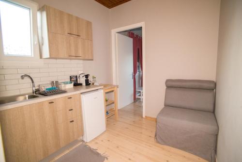 a kitchen with a sink and a chair in a room at Tsonas Apartments in Lygia