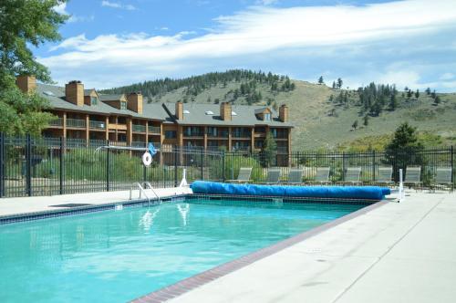 a pool in front of a resort with a building at The Inn at Silvercreek in Granby