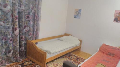 a small room with a bed and a curtain at Apartment Mehi in Pazarić