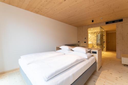 a bedroom with two white beds and a mirror at Mari Pop Hotel in Ried im Zillertal
