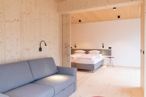 a living room with a couch and a bed at Mari Pop Hotel in Ried im Zillertal