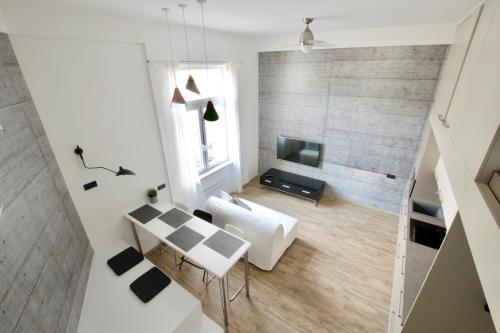 a living room with a table and a tv at Standard Apartment by Hi5 - Gellért Spa Area in Budapest