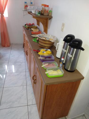 a kitchen with a counter with food on it at Pousada Jatobá in Barreirinhas