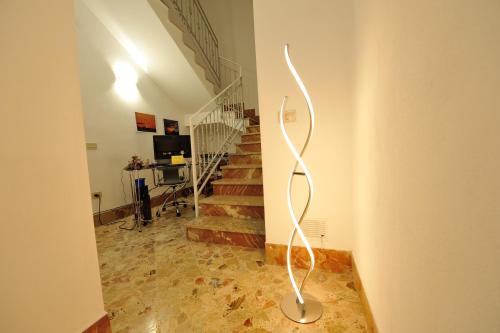 a metal sculpture in a room with stairs at Terra Sinus Holiday House in Terrasini