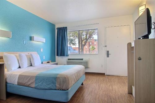 a bedroom with a large bed and a window at Motel 6-Lubbock, TX in Lubbock