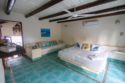 a bedroom with a bed and a pool in it at Tintipan Cabana SalSiPuedes in Tintipan Island