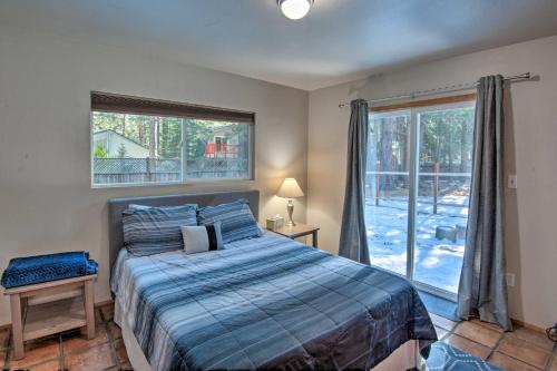 a bedroom with a bed and a large window at Cozy Mountain Cabin about 7 Mi to Heavenly Ski Resort! in South Lake Tahoe