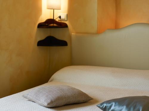 a bedroom with a bed with a pillow on it at Monastero San Silvestro in Cortona