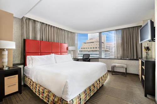 a hotel room with a large bed and a large window at Holiday Inn Express Denver Downtown, an IHG Hotel in Denver