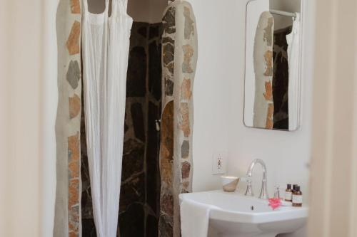 a bathroom with a white sink and a shower at Korakia Pensione in Palm Springs