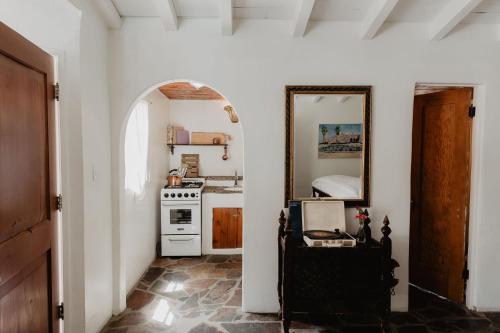 a kitchen with a stove and a mirror at Korakia Pensione in Palm Springs