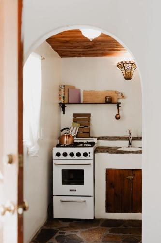 a kitchen with a white stove and a sink at Korakia Pensione in Palm Springs