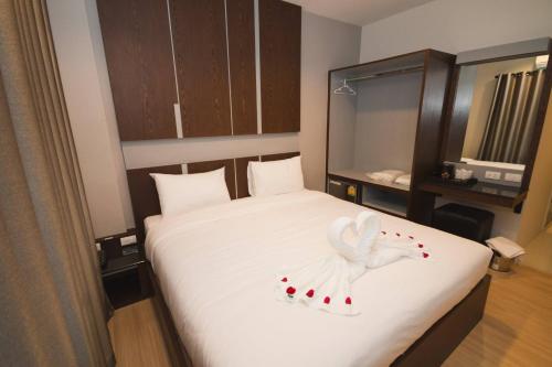 um quarto com uma cama com um anjo branco em The Y Smart Hotel em Chiang Mai