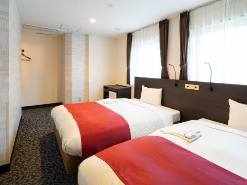Postel nebo postele na pokoji v ubytování Ai Hotel Keikyu Kamata