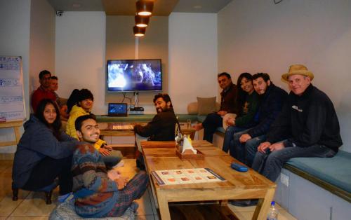 a group of people sitting in a room at Blue Beds Hostel in Jaipur