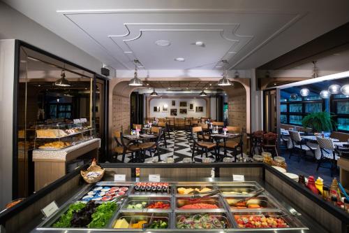 a restaurant with a display of fruits and vegetables at De Chai the Deco Chiang Mai - SHA Plus in Chiang Mai