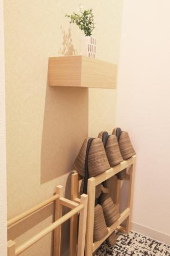 a wooden shelf with plates in a room at GRAND BASE Osu in Nagoya