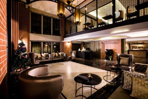 a lobby with a christmas tree in the middle at De Chai the Deco Chiang Mai - SHA Plus in Chiang Mai