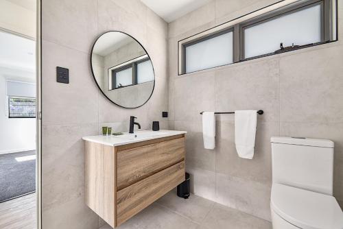 a bathroom with a sink and a mirror at Southern Apartments Launceston in Launceston
