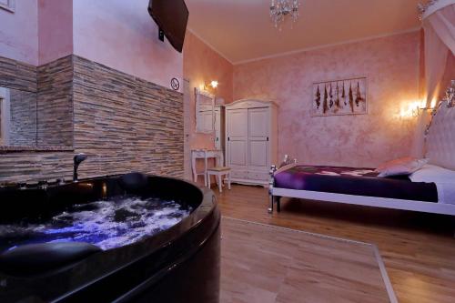 Habitación con bañera, cama y dormitorio. en Deluxe rooms and Chilling Jacuzzi Suite Guesthouse, en Roma