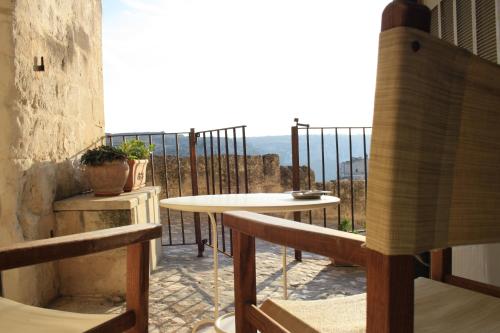 a balcony with a table and a view of the ocean at Locus Amoenus in Matera