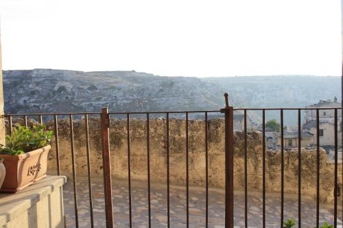 a balcony with a wrought iron fence with a view at Locus Amoenus in Matera
