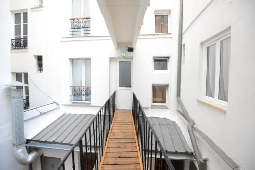 a hallway of a building with a wooden walkway at LAFAYETTE HOTEL in Paris