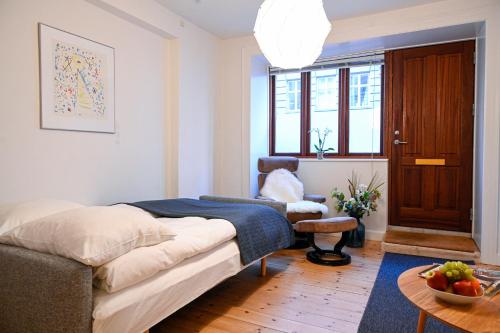 a bedroom with a bed and a chair and a table at Sanders Park - Charming 1-Bdr Apt Close to Metro in Copenhagen