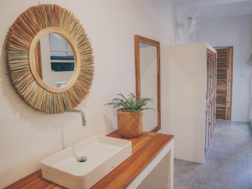a bathroom with a sink and a mirror at Arya Wellness - female only in Ubud