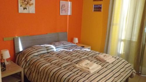 a bed with two bags on it in a room at Bed Relax Etnaview in Zafferana Etnea
