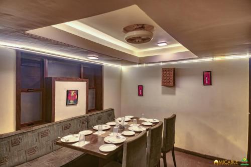 a dining room with a long table and chairs at Hotel Ashwin Igatpuri, Pure Veg & Jain Food in Igatpuri