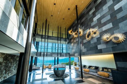 a lobby of a building with a view of the ocean at ANA InterContinental Beppu Resort & Spa by IHG in Beppu