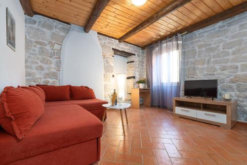 a living room with a couch and a tv at PERLA VRSAR in Vrsar