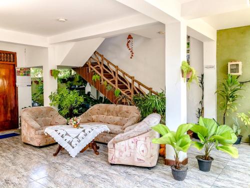 a living room with two couches and a table at Eden Homestay in Hikkaduwa