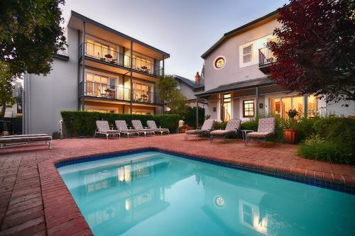 a swimming pool in front of a house at Bonne Esperance Boutique Guest House in Stellenbosch