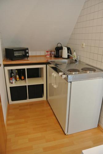 a small kitchen with a sink and a stove at Rheinau Apartment in Memprechtshofen