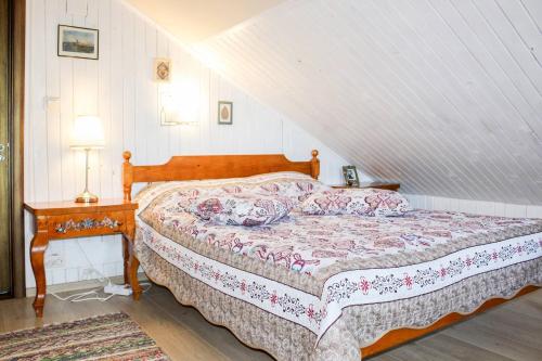 a bedroom with a bed and a table with a lamp at Casa Roua Muntilor in Câmpulung Moldovenesc