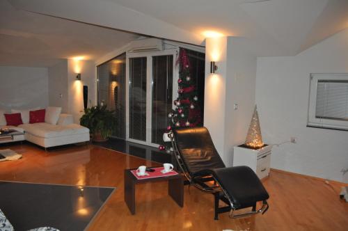 a living room with a christmas tree and a couch at Comfort Deluxe Kosmos Apartments in Ohrid
