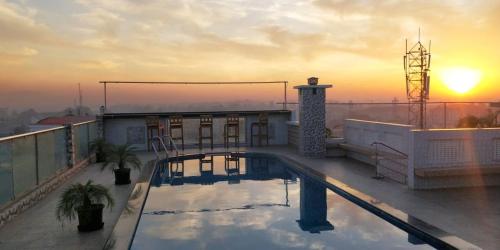 a swimming pool on the roof of a building at Hotel Lake Shilloi in Dimāpur