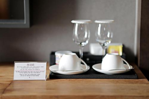 a table with two napkins and two wine glasses at Best Louis Hamilton Hotel Haeundae in Busan