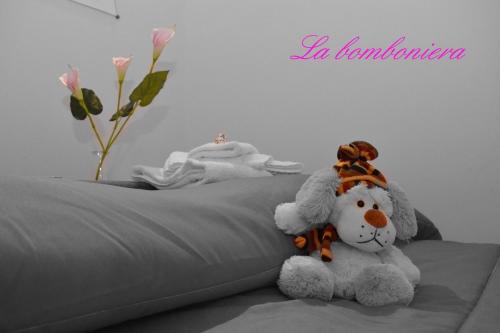 a teddy bear sitting on top of a bed at La Bomboniera in Maiori