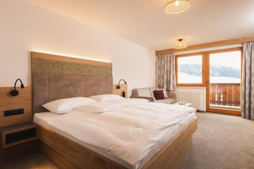 Una cama o camas en una habitación de Apart Pension Moos - inklusive SuperSommerCard