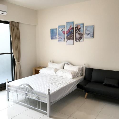 a bedroom with a bed with four pictures on the wall at Chiang Mi No.1 B&B in Chaozhou