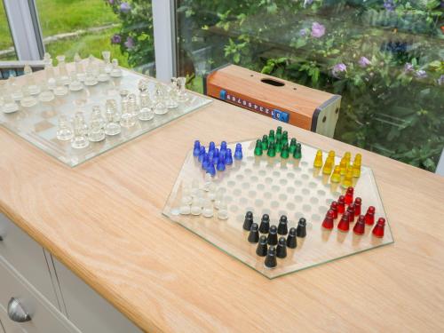 two chess boards on a table with drinking glasses at Merlin's Retreat in Tintagel