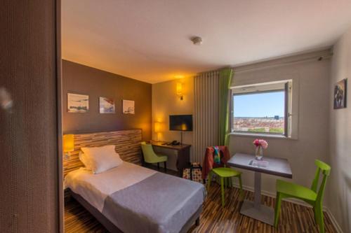 a bedroom with a bed and a desk and a table at Résidence Villemanzy in Lyon