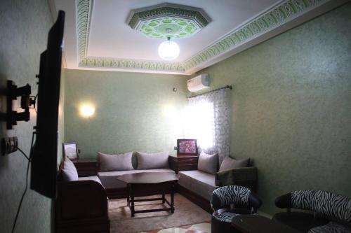 a living room with a couch and a table at Résidence dikre in Ouarzazate