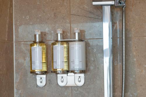 a group of four oxygen bottles hanging on a wall at The Psalter in Sheffield