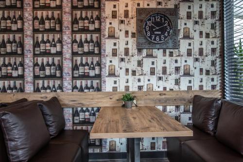 a room with a table and a wall of wine bottles at Hotel Idol in Targovishte